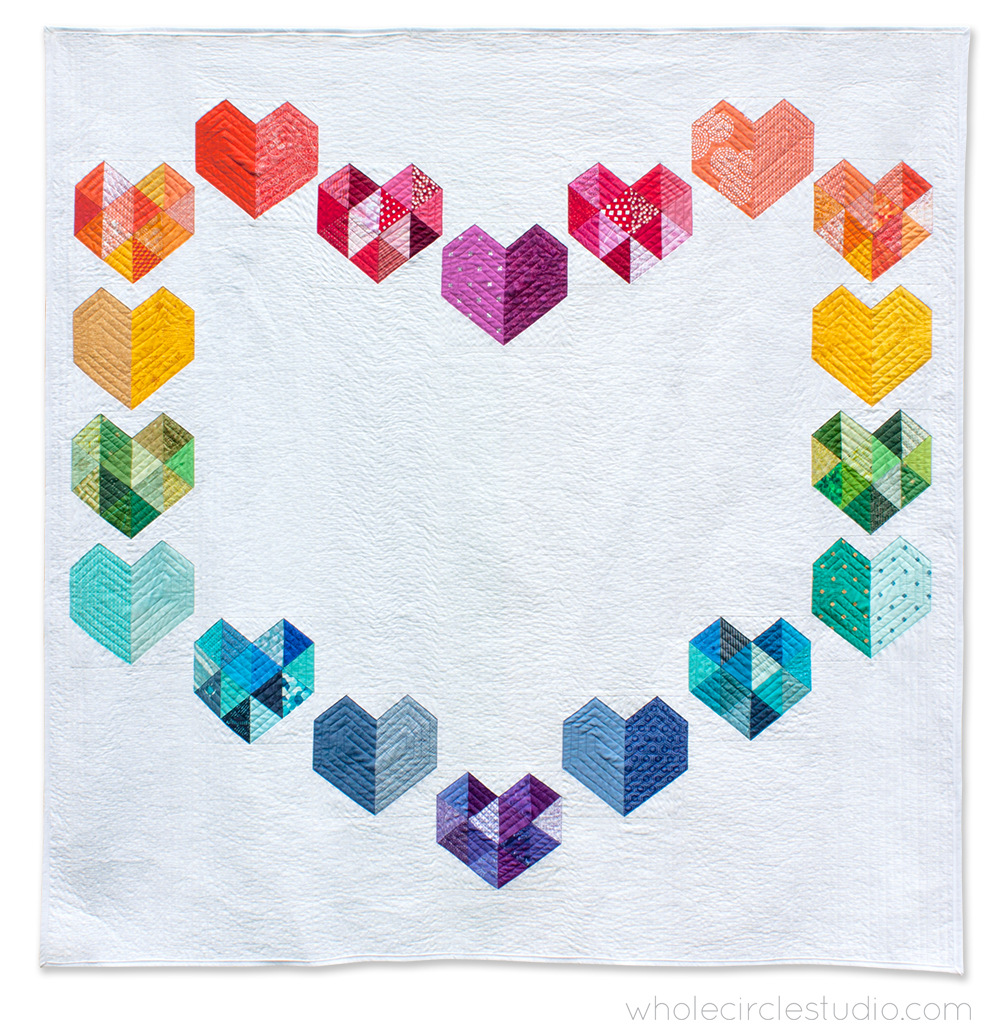 rainbow color palette quilt of heart blocks arranged in a heart shape