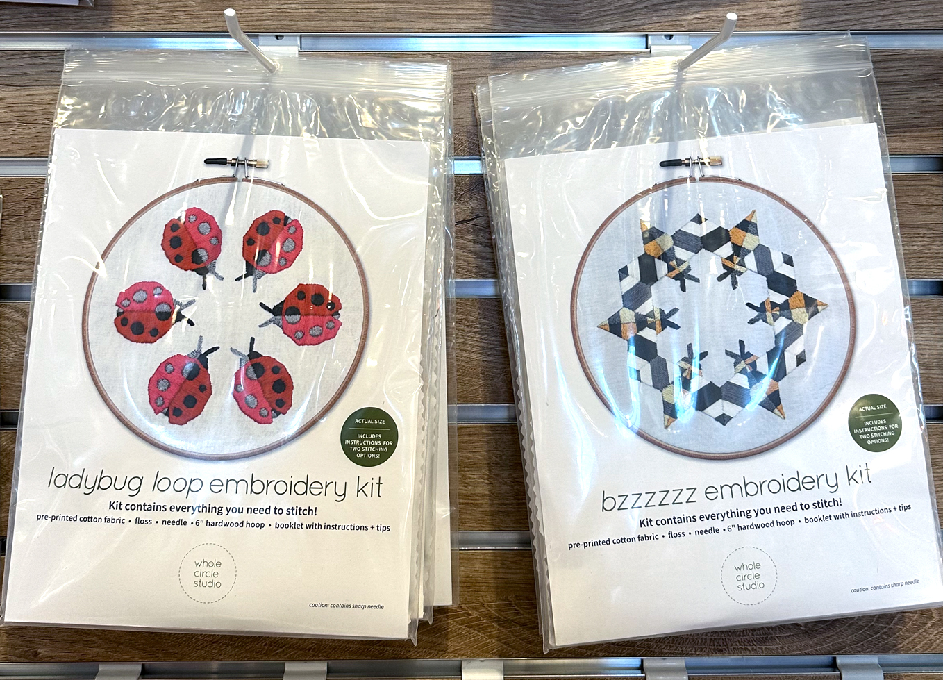 two embroidery kits that look like ladybugs and bees in a circle