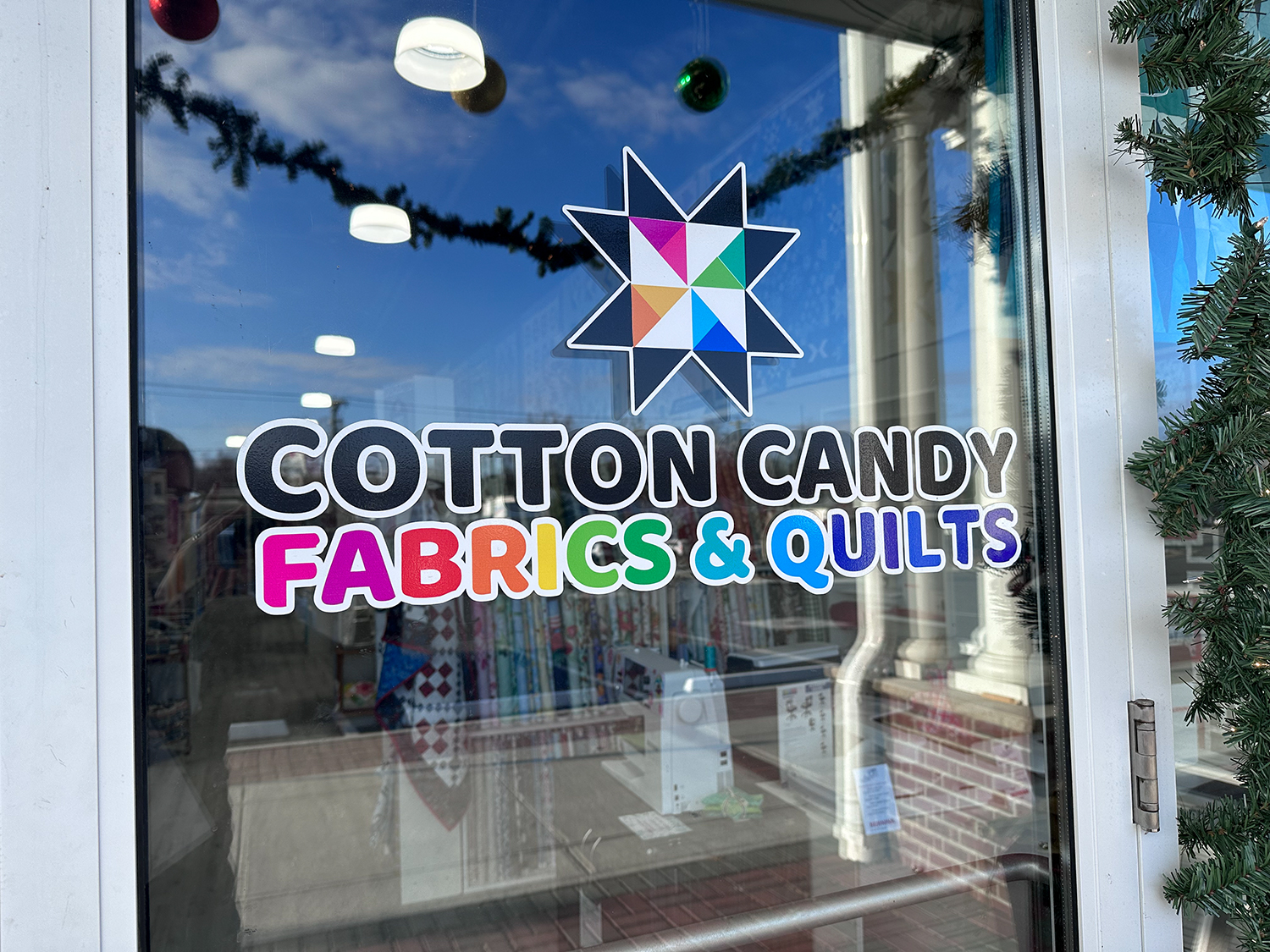 colorful logo with a quilt block for a quilt shop