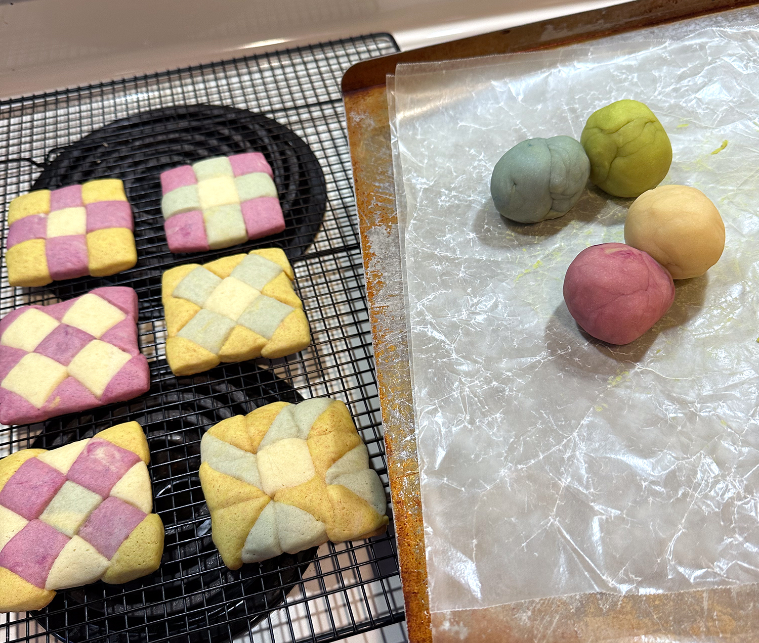 colorful cookies and balls of colorful uncooked cookie dough