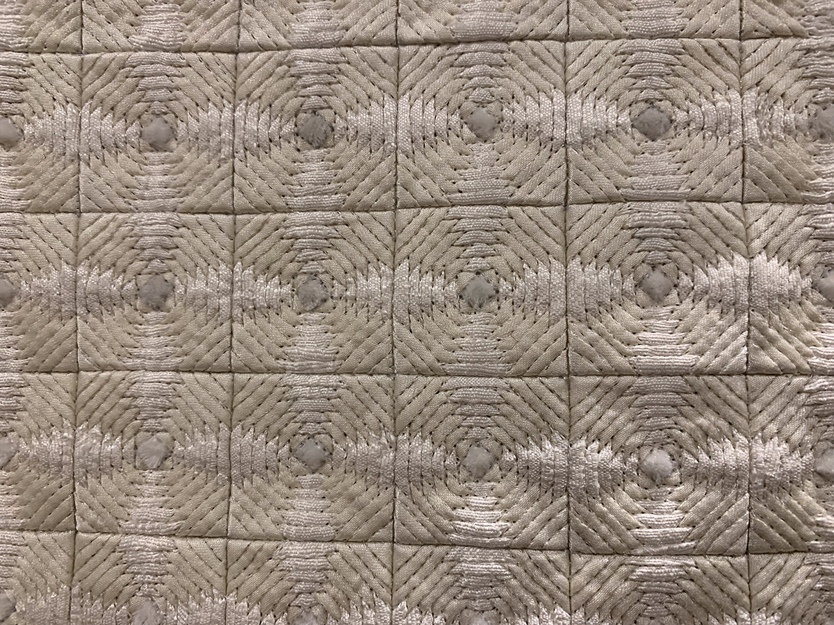 detail of neutral, gemoetric quilt