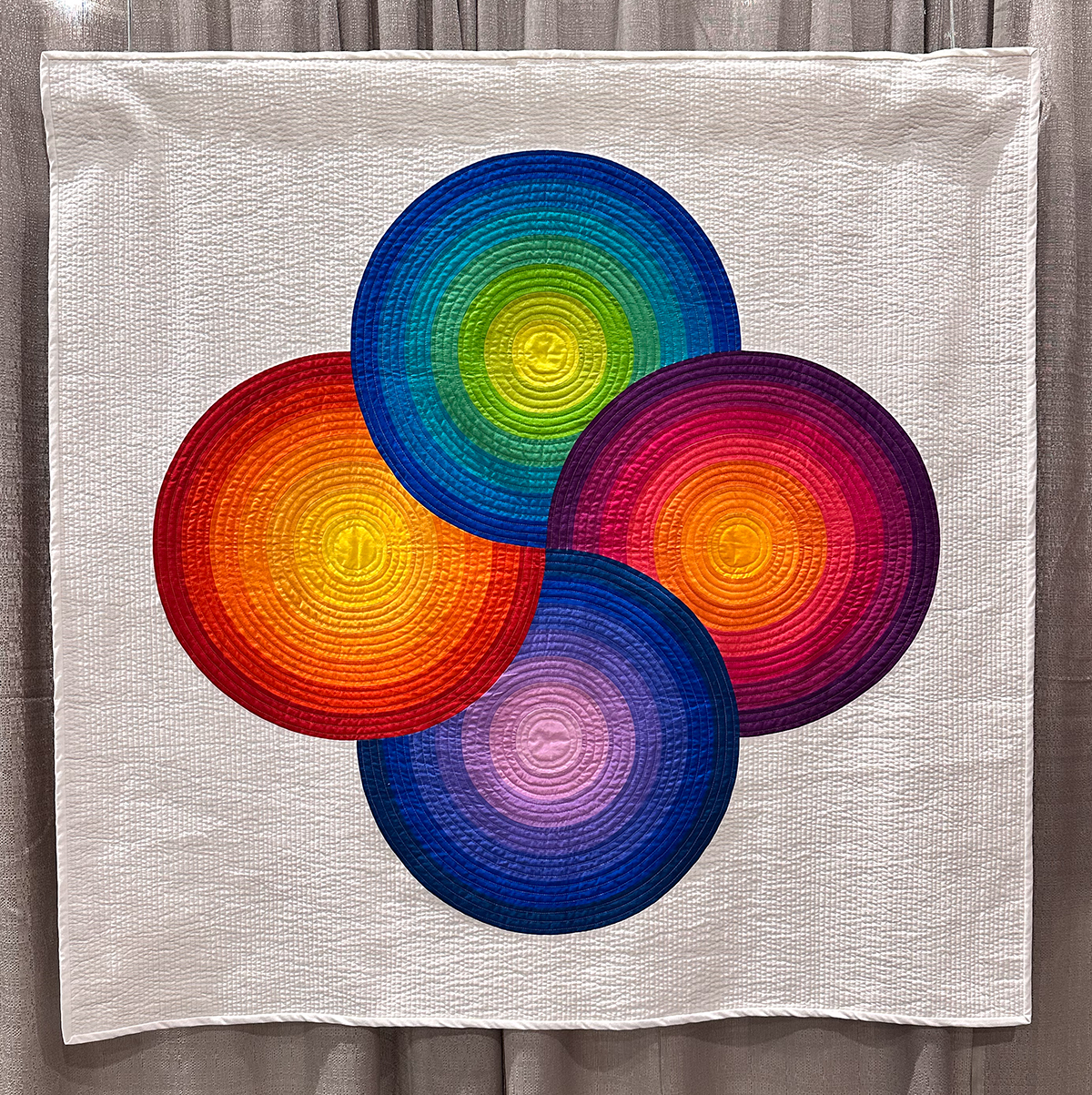 colorful quilt of 4 circles interlocking in the middle