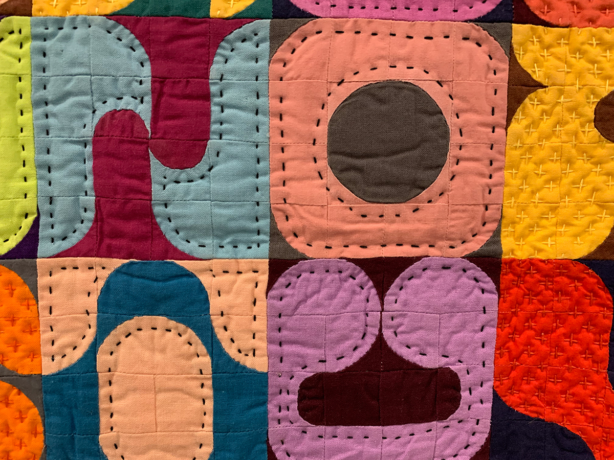 detail of colorful, typography modern quilt 