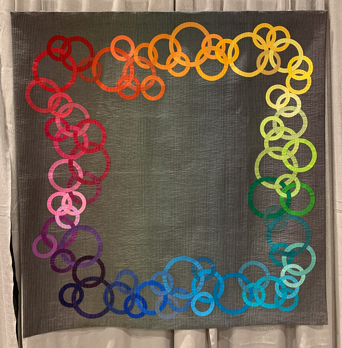 colorful quilt of circles in a square arrangment
