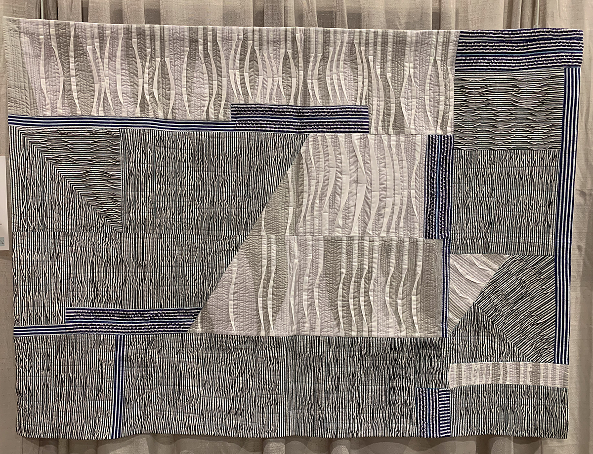 detail of geometric modern quilt: black, white and neutral colors with lots of lines