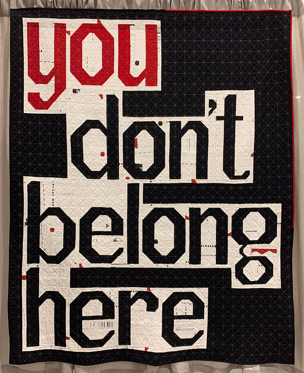 quilt with words "you don't belong here"