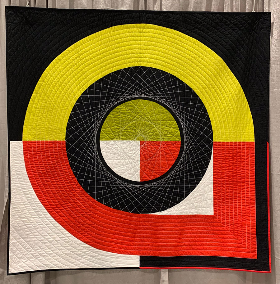 quilt with black, red, green, and white circles