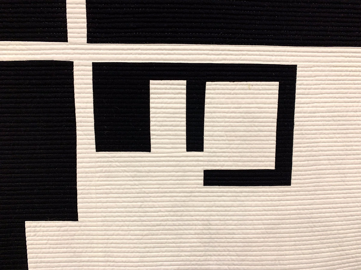 detail of black and white geometric quilt