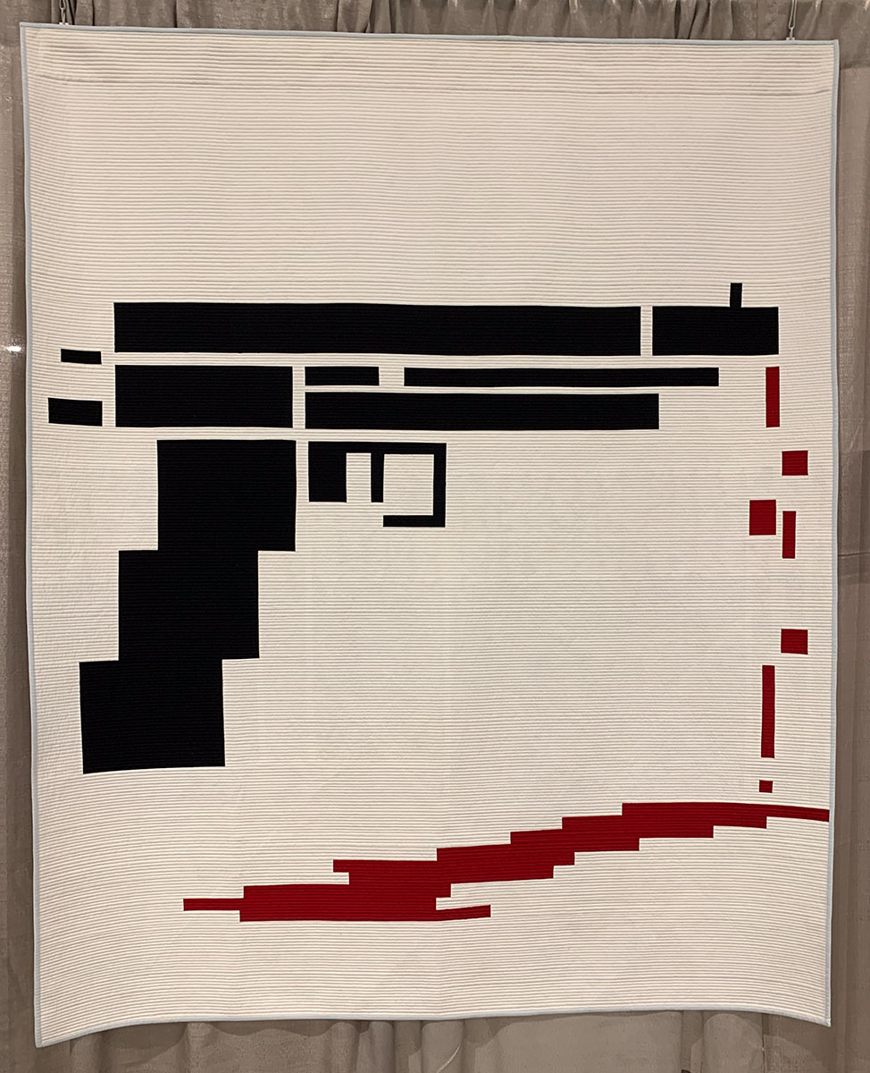 quilt with graphic of gun and dripping blood
