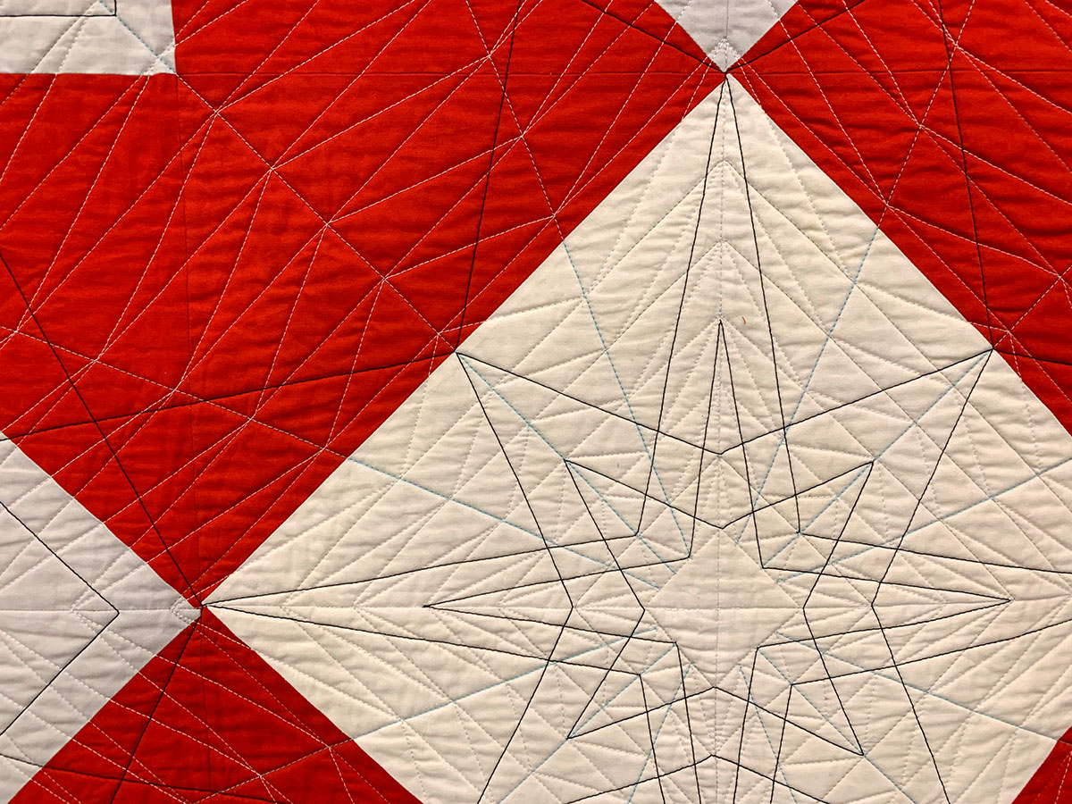 detail of geometric quilt: red and white