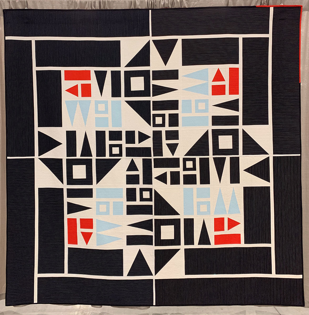 geometric quilt: blue, white, black and red