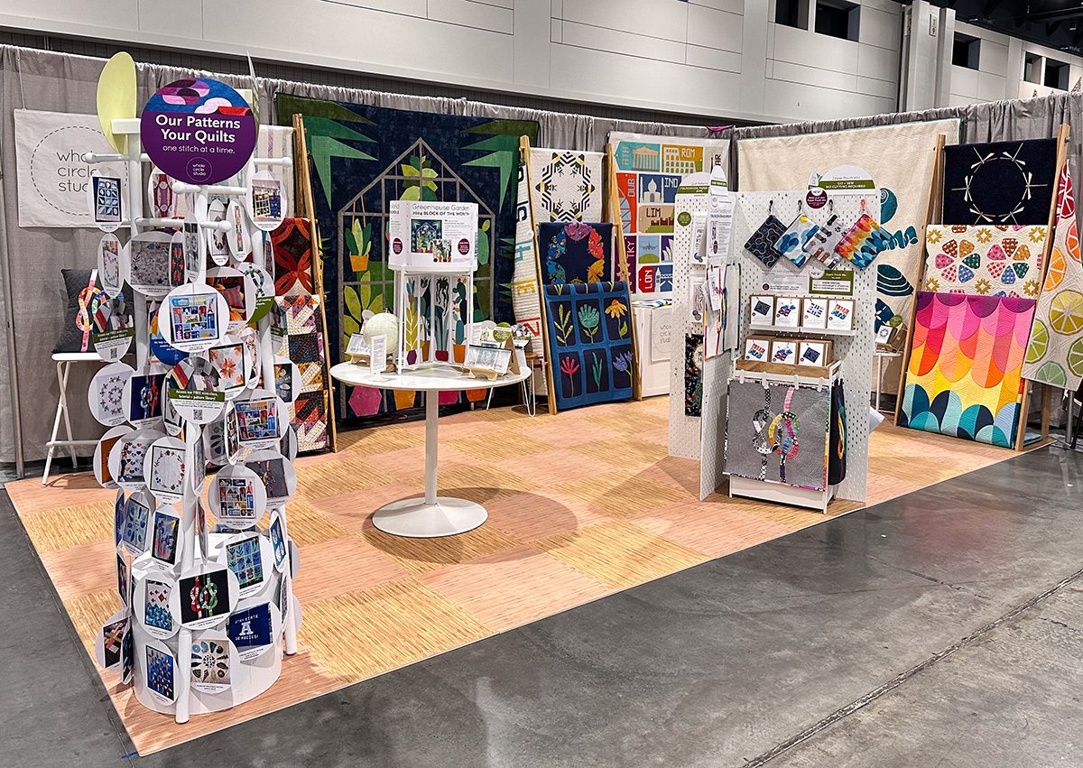 colorful trade show booth with quilts