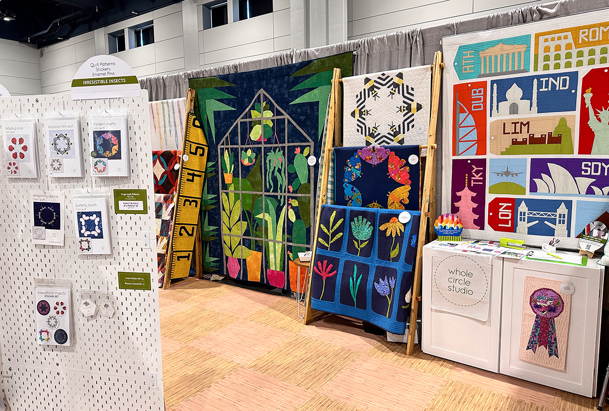 colorful trade show booth with quilts