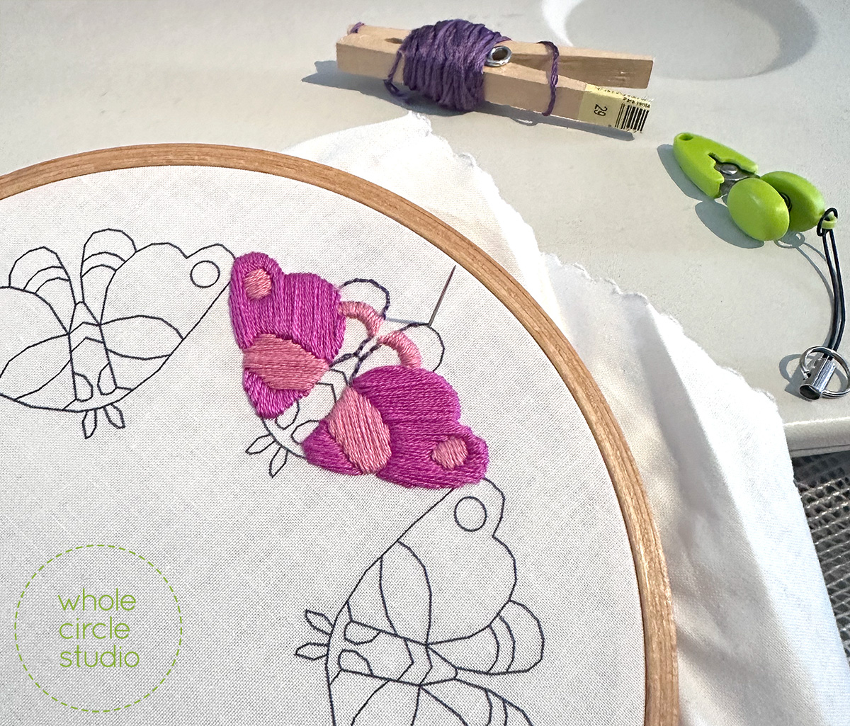 embroidery of colorful moths in progress