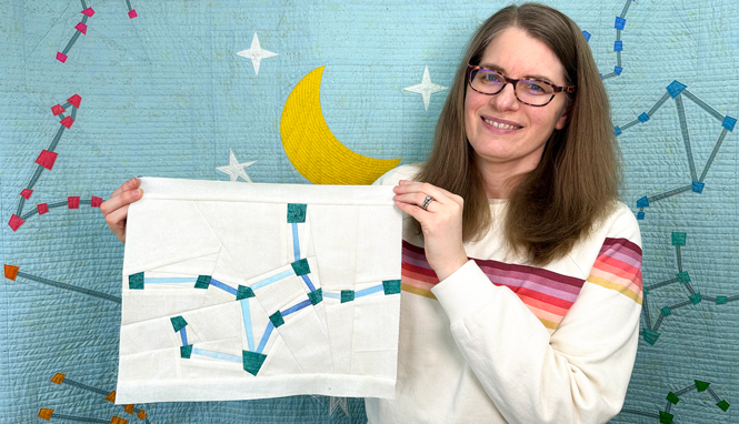 woman holding a Virgo zodiac star zodiac star quilt block