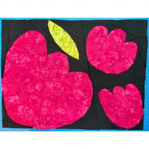 hot pink flower quilt block on a black background with a green leaf