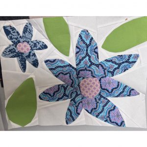 flower quilt block made with bold geometric print fabric