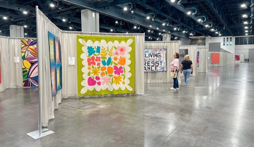 modern flower quilt hanging in quilt show