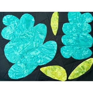 large foundation paper pieced flower quilt block made with blue and green batik fabrics