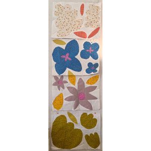 row of colorful flower quilt blocks made with floral fabric and scraps of white fabric