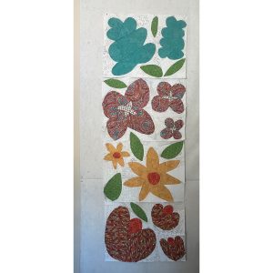 row of colorful flower quilt blocks made with floral fabric and scraps of white fabric
