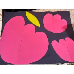 3 flowers quilt block made with magenta, green, and navy fabric