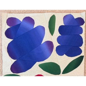 large foundation paper pieced flower quilt block made with blue and green batik fabrics