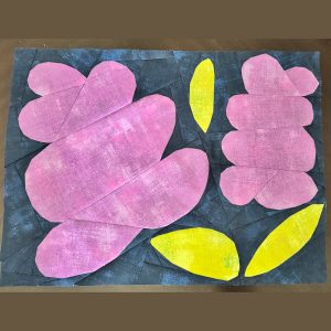 lilac quilt block made with distressed purple, green, and navy fabric