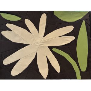 abstract flower quilt block made with white, green, and brown fabric