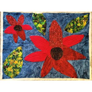 flower quilt block made with red, yellow, green, and navy blue batik fabrics