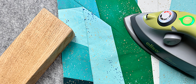 Pressing a paper pieced quilt block with a mini iron